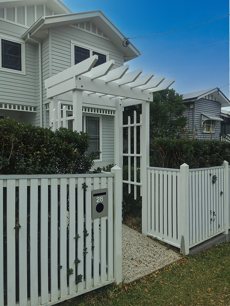 This entrance Arbour has been painted white to match the white accent colors in the residence.