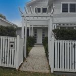 The entrance Arbour creates a lovely pathway through the gate with balustrading added to match the existing fence.