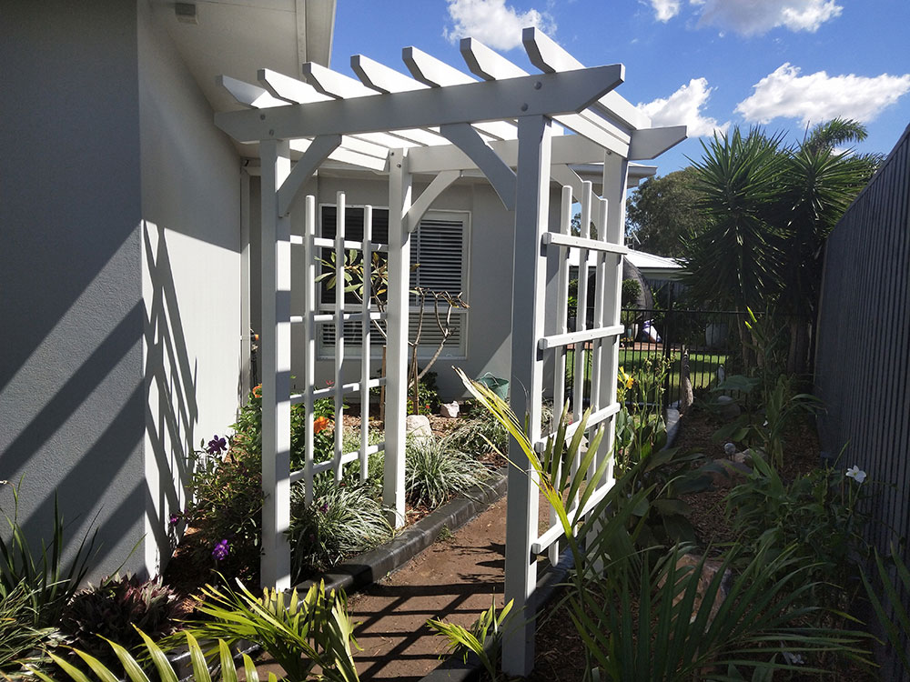 This arbour has been set at the corner of the house and they are planning to have flowering vines covering it.