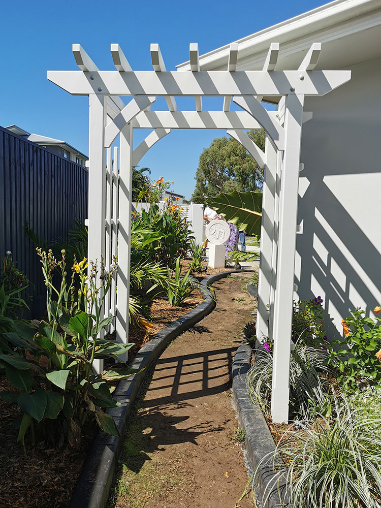 Looking towards the front of the residence the Arbour frames the garden path and features.