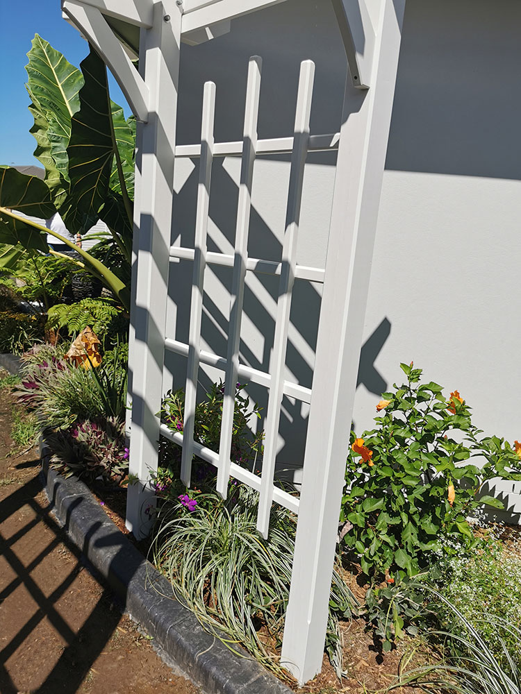 Screening has been added to the side of this Surfmist Painted Arbour so that flowering vines can climb and cover the Arbour.