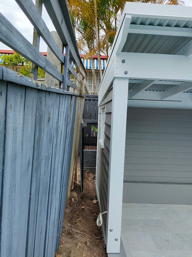 The wall on the side of the Cabana has been set into the corner of the property block. This side wall has Cedar Weatherboard siding on the exterior and interior.