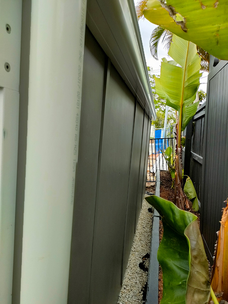 The back wall has been set close to the rear boundary. The Cedar weatherboard siding was used on the interior and a Hardie Board concrete sheeting was used on the exterior. Special ordered metal flashings have been installed for water protection.