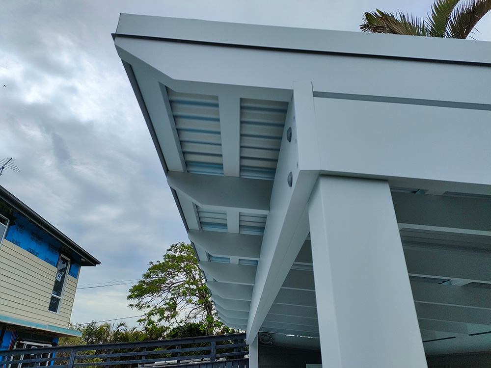 This Pool Cabana has been designed with a roof style of a Pergola with a front cantilever overhang. The modern style looks great with the beams set onto a post ledge. The front beam is a laminated double beam to span the entire distance of this wide structure.