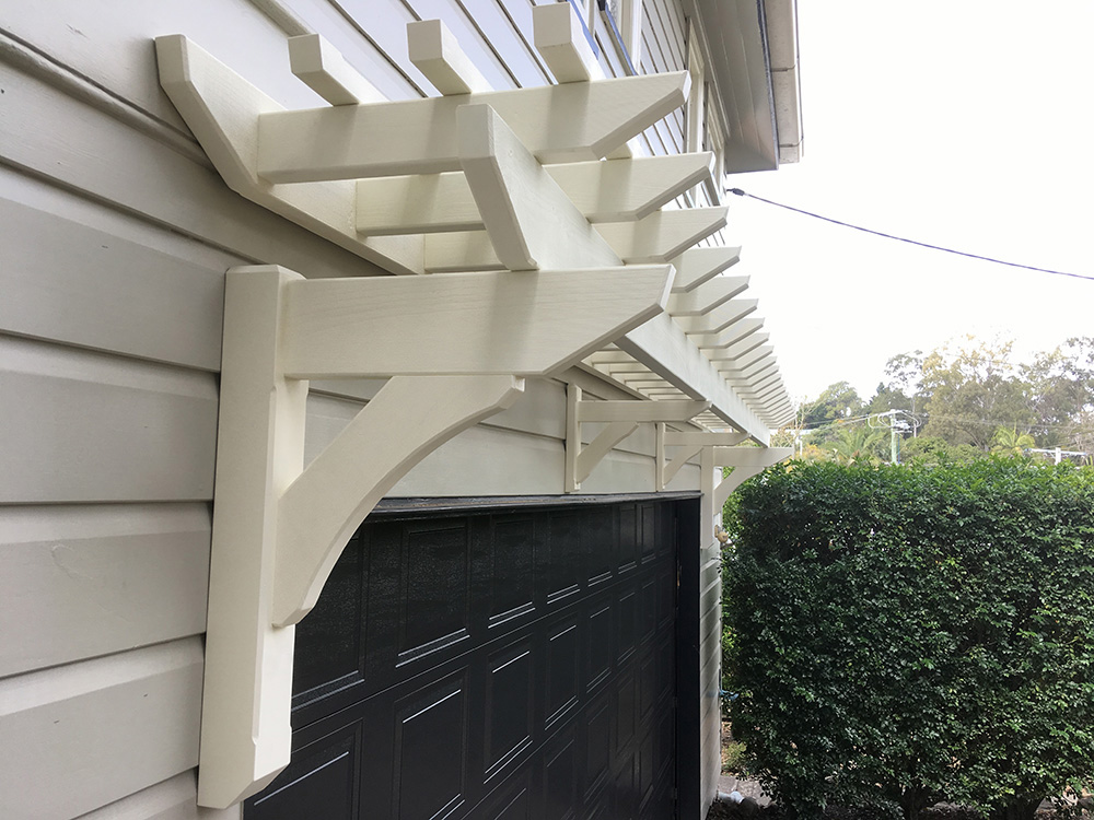 Painted Eyebrow Garage Pergola to match 1915 style Queenslander features and accents. Designed to create a feature for the side of the house above the garage.