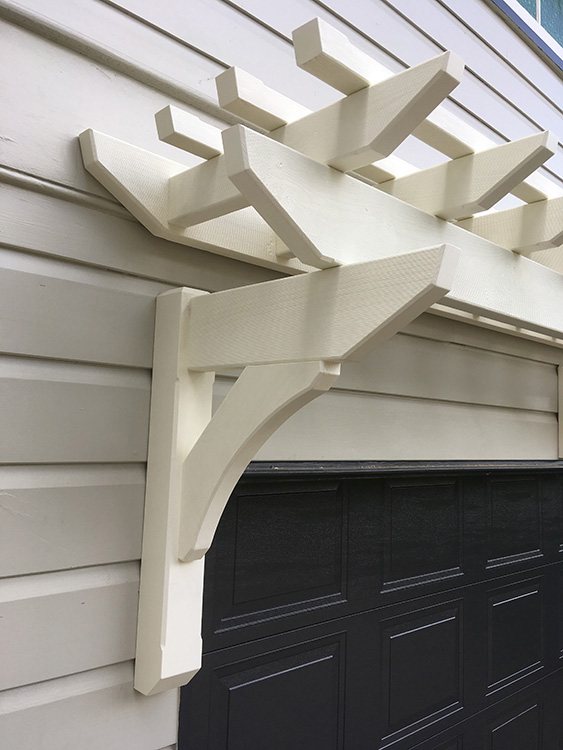 Painted Eyebrow Garage Pergola to match 1915 style Queenslander features and accents. Designed to create a feature for the side of the house above the garage.