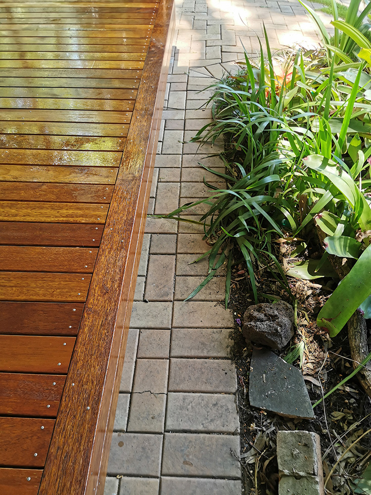 This deck has been constructed from Pine deck framing with a Merbau decking and surround. Set above the pavers it looks great in the treed setting.