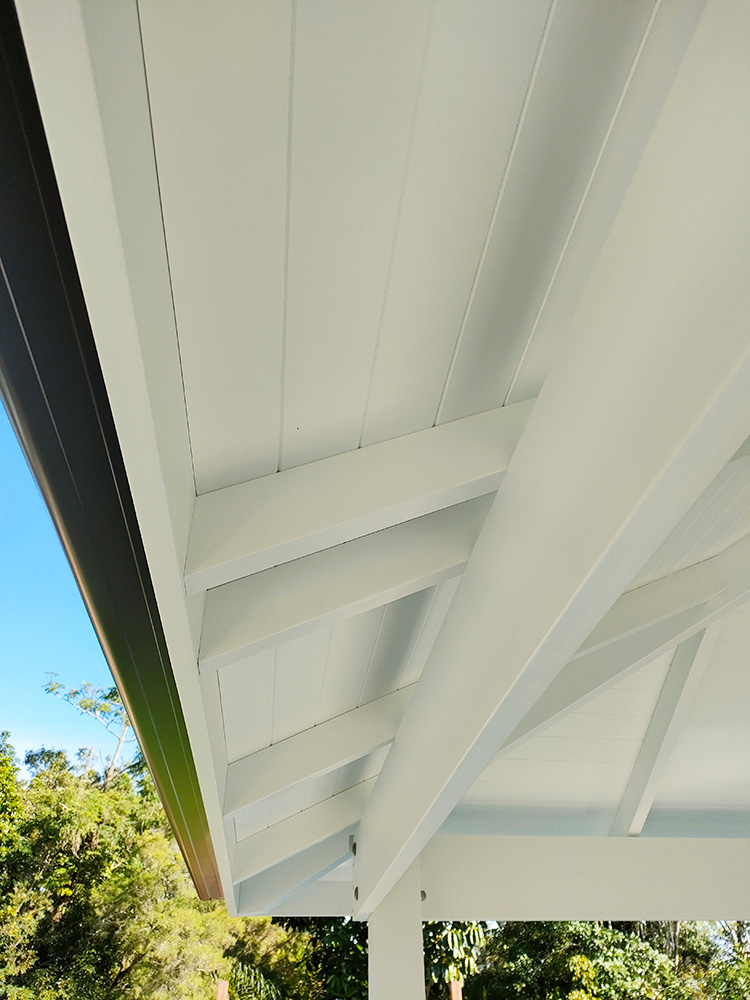 This painted Pine Gazebo with VJ Ceiling has an overhang, you can see here that the rafters travel over the beams to the outer fascia boards. The VJ Ceiling has been fit very precisely with no trim and it has an outstanding finish.