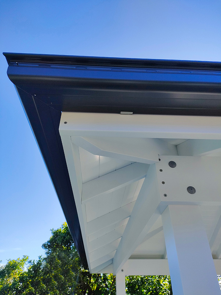 White painted Pine. The gutter corners are meticulously cut and installed for flawless finish.