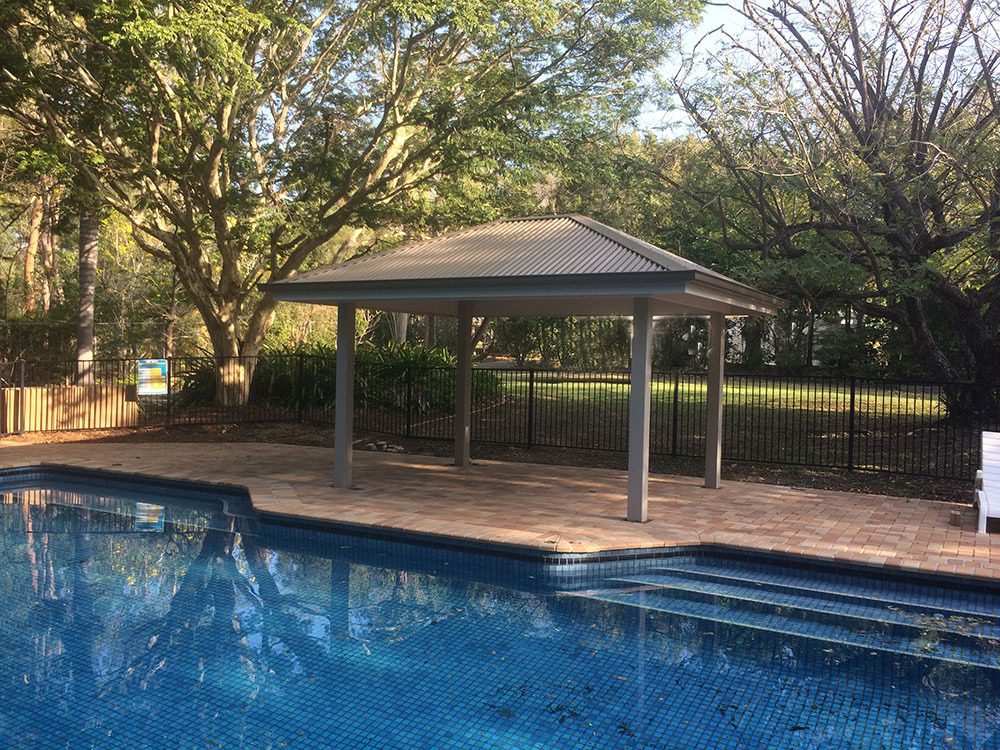 Gazebo set into existing pool surround. Painted Gazebo with hardwood posts concreted in ground.