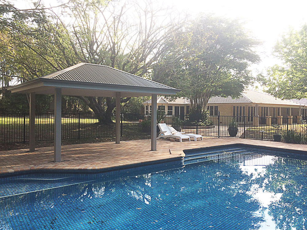 Gazebo set into existing pool surround. Painted Gazebo with hardwood posts concreted in ground.