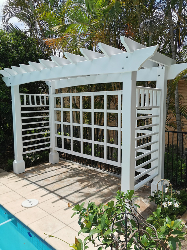 This white Pergola has many features including arched beams, screening and decorative boxes.