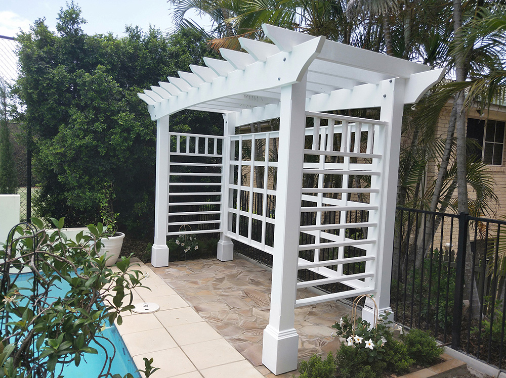 This white Pergola has many features including arched beams, screening and decorative boxes.