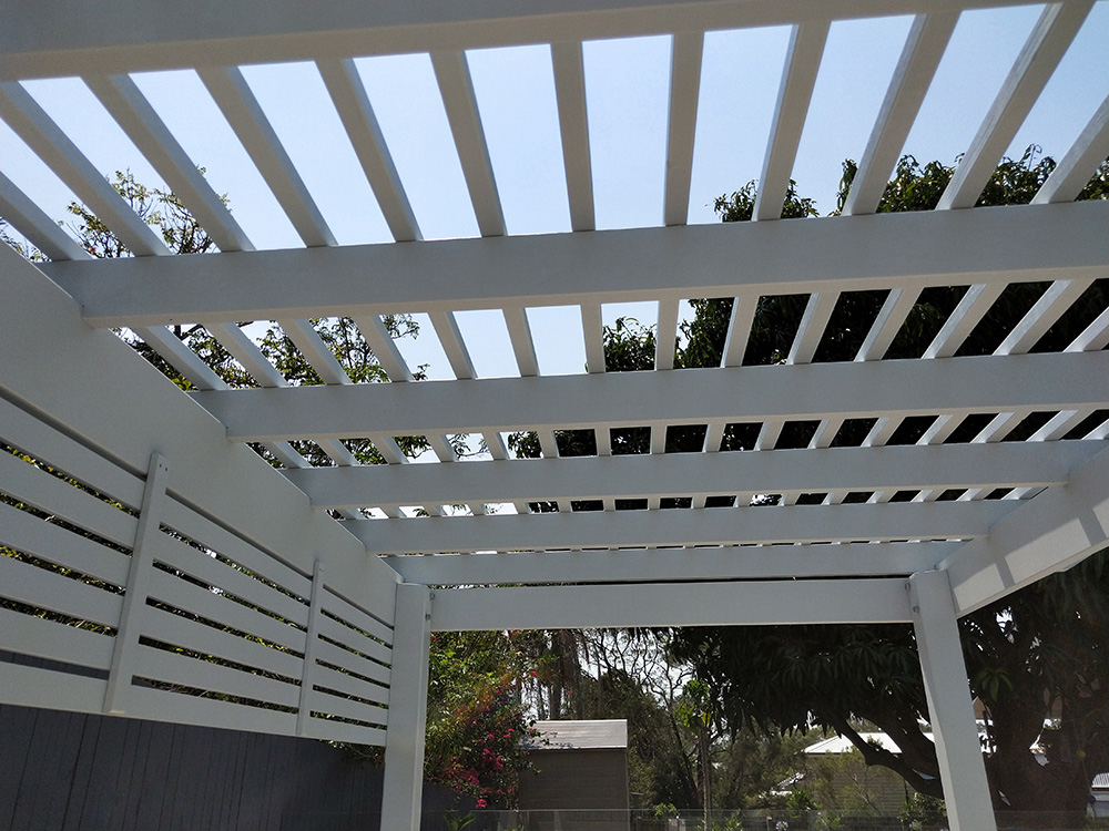 This Pergola has a tightly set battens and screening on two sides to provide a nicely shaded private area by the pool side.