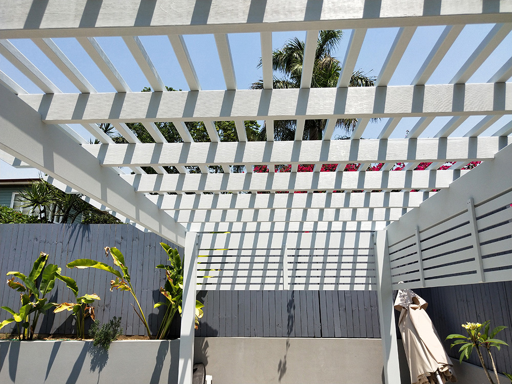 This Pergola has a tightly set battens and screening on two sides to provide a nicely shaded private area by the pool side.