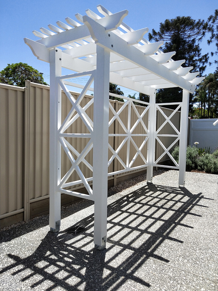 This white painted Pergola has been set into the turning circle of this residence so that it compliments and adds depth to the front of the residence.