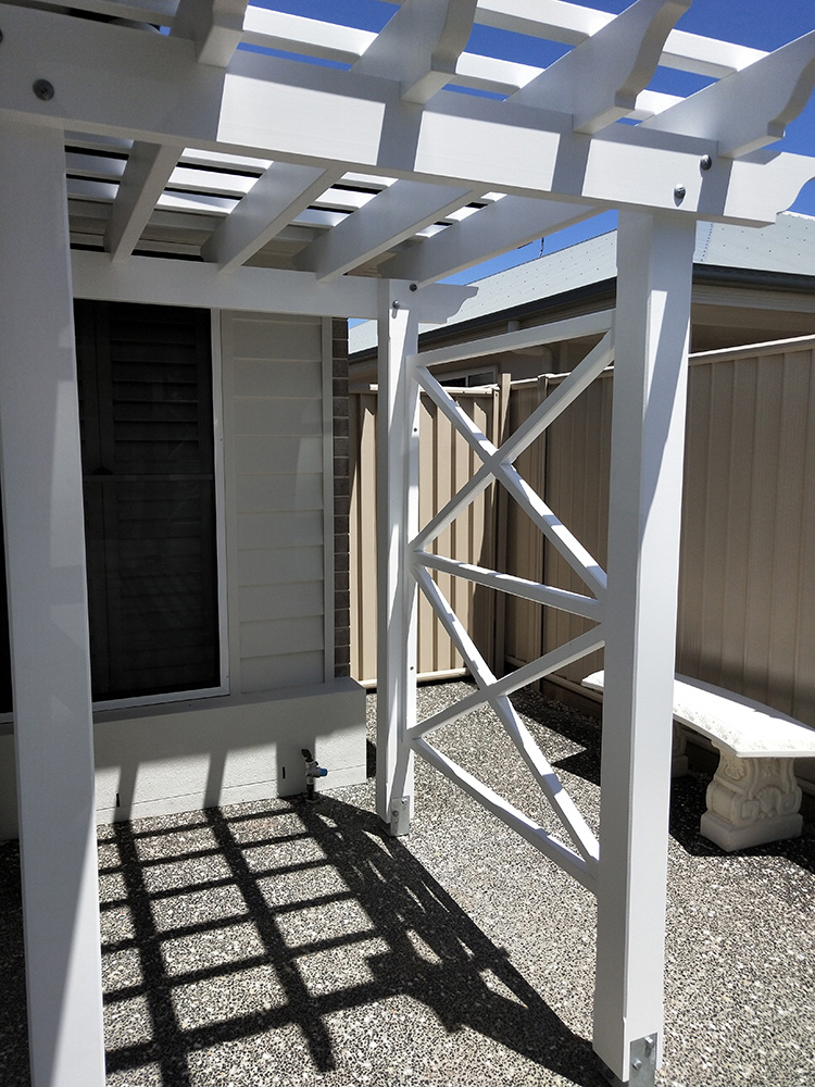 This white Pergola has been set just under the soffit of the residence and the X screening has been made to complement the existing aspect features.