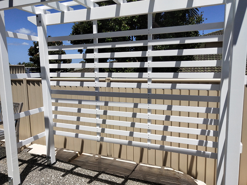 This Pergola has horizontal screening added to the back and sides which will provide both privacy screening and added green space with a new sitting area when the bench seat is added.