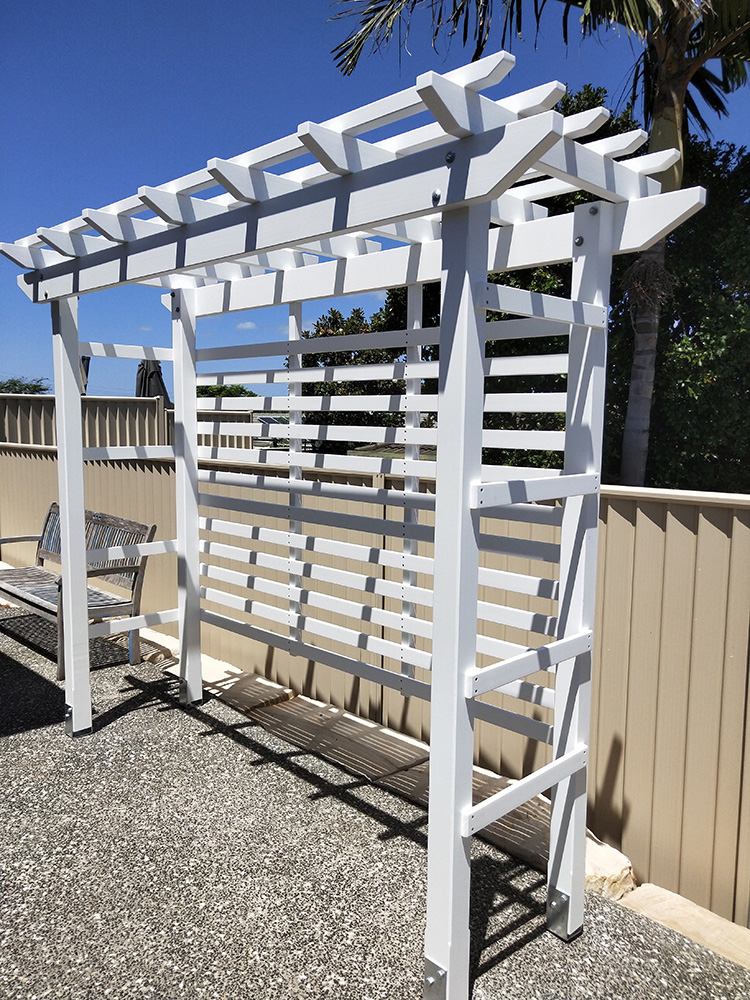 This painted white pergola is set at the back of the residence to provide further depth and added green space once the Pergola has had a flowering vine added.