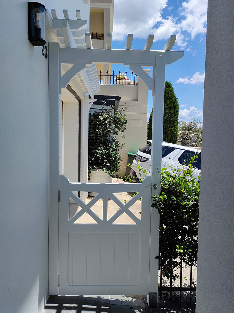 This Arbour has been designed to fit into an existing gate entrance. The old metal gate was removed and the new Gate with Arbour has been fit.