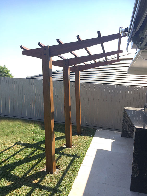 Spotted Gum Cantilever Pergola concreted in ground with mortised rafter and posts connection.