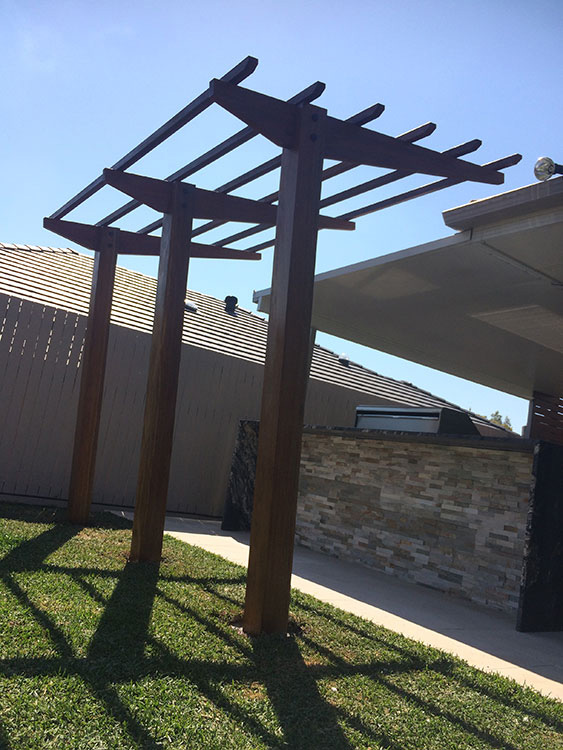 Spotted Gum Cantilever Pergola concreted in ground with mortised rafter and posts connection.