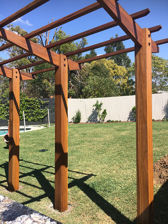 Spotted Gum Cantilever Pergola concreted in ground with mortised rafter and posts connection.