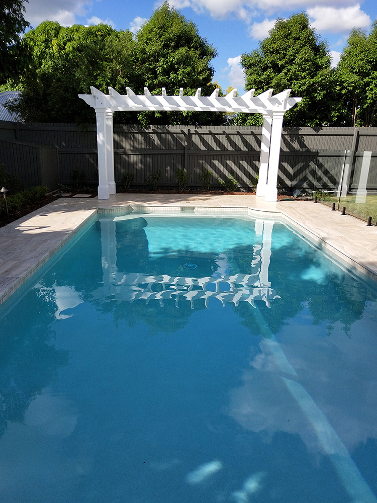 A beautiful Pergola to compliment the pool area beside this Hampton's house.