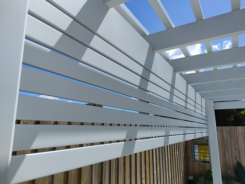 Screening has been added to the back of this Pergola creating a lovely view from the house towards the back of the property showcasing the view of the Pergola.
