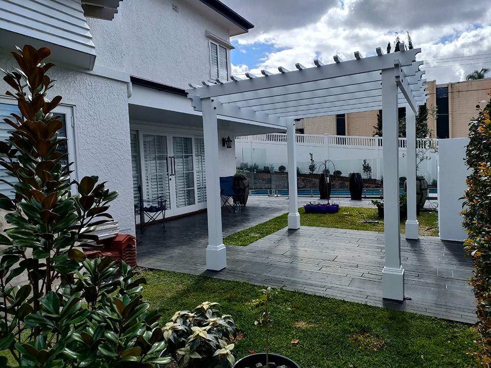 This new painted Pine Pergola creates a new sitting area outside the french door bottom entrance and overlooking the pool area.