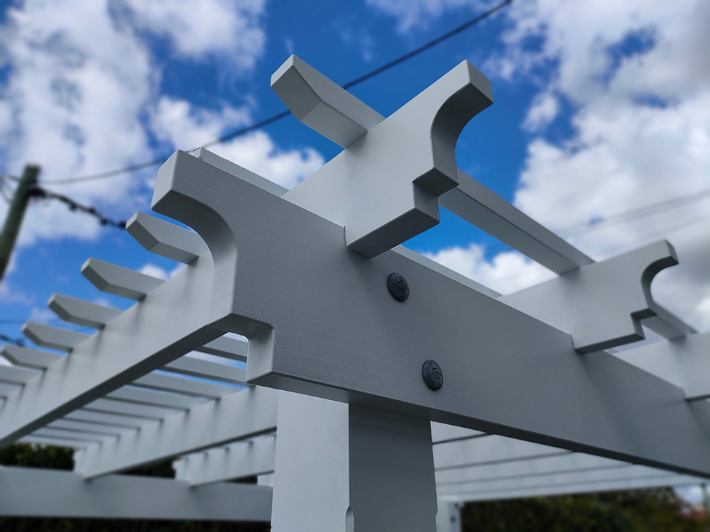 The painted Pine Pergola looks fantastic with knotched in rafters over the main beams.