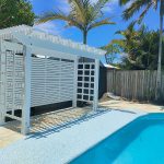 This painted white Pine Pergola creates a lovely new sitting area beside the pool.