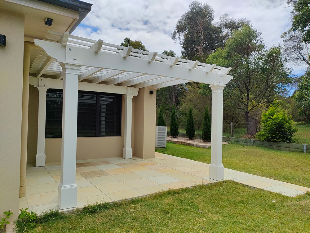 The Pergola has been set just under the soffit of the house and from the inside it frames the window looking out towards the front yard and extending the master bedroom.