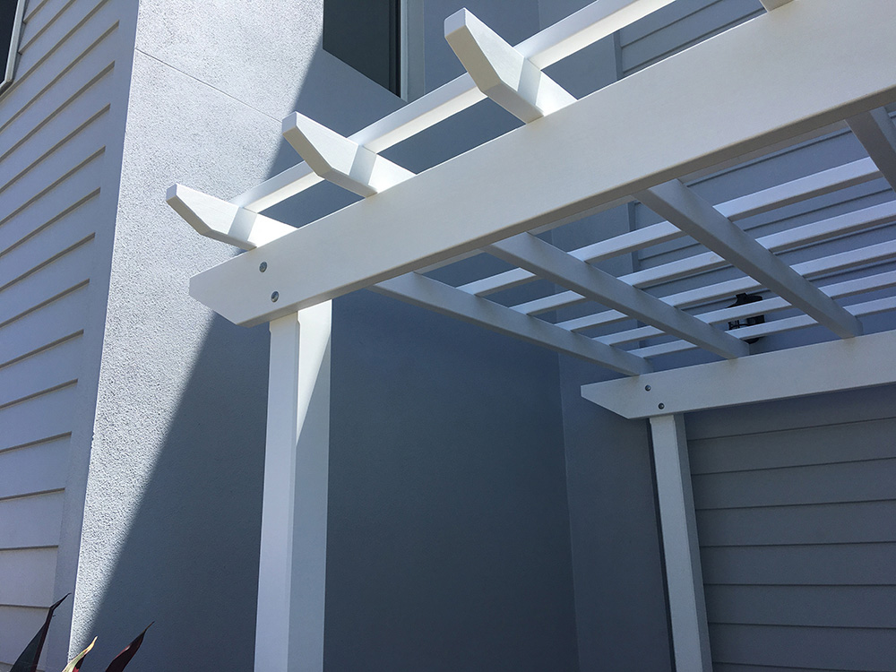 This Pergola has been set into this entrance area. Adding both depth an visual appeal it creates a great new entrance way to for this residence.