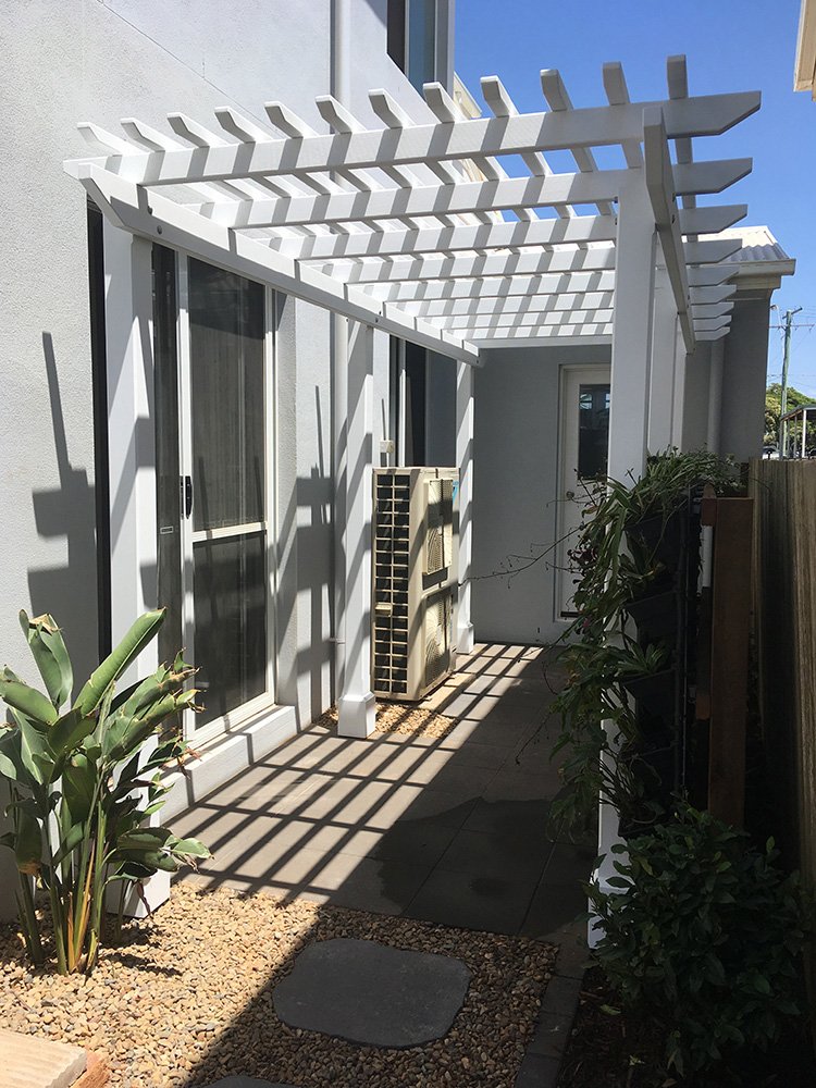 Pine Pergola set into the side entrance, complimenting the new green wall and set into newly paved area.