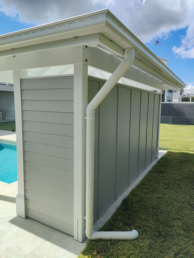 This Grey and White Pool Cabana has a clean cut back wall. You can add hooks to hang the pool equipment or add storage to hide all the pool toys and gear creating a tidy and clean outdoor area by the pool.