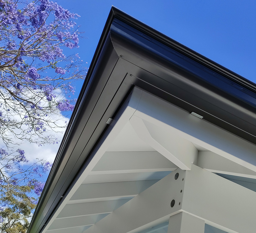 Roof Gutters fit to perfection shown in combination with exposed rafters that have a premium painted finish.