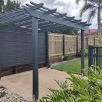 This Pergola Kit has been customized to adjust the size slightly, painted in Monument, add back screening and includes installation.