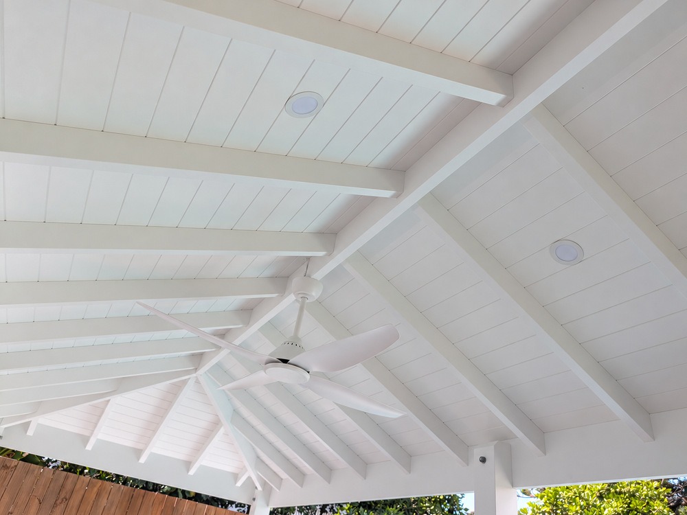 Close view of white VJ ceiling lining and exposed painted timber rafters inside the Pool Cabana.