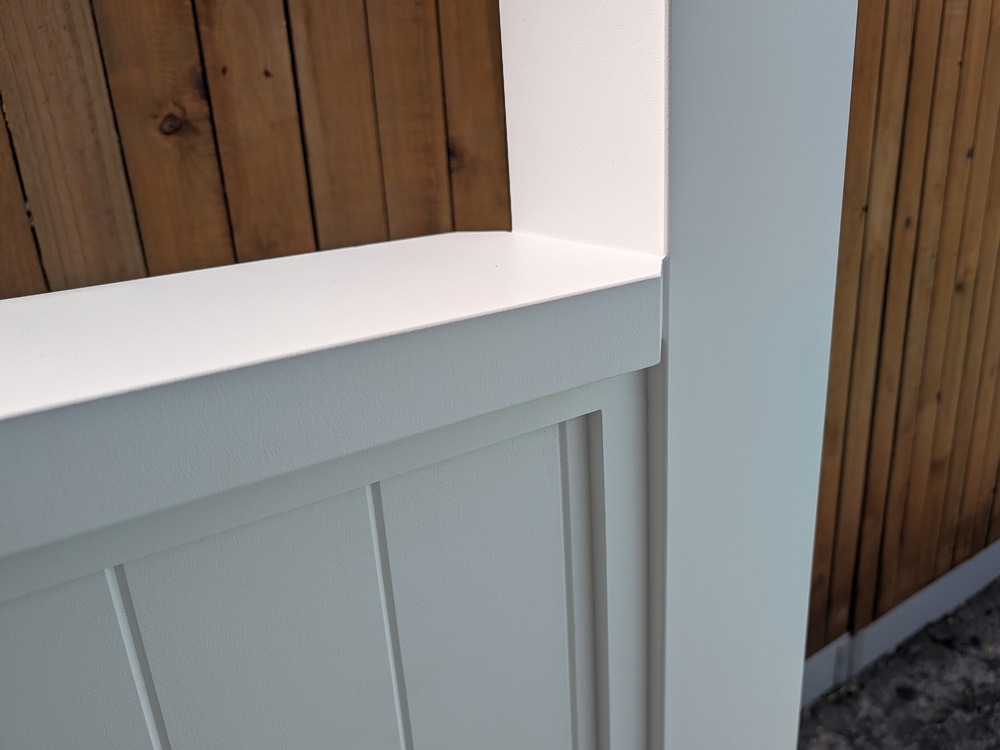 White capping and VJ lining on the Cabana’s half side wall beside the timber boundary fence.