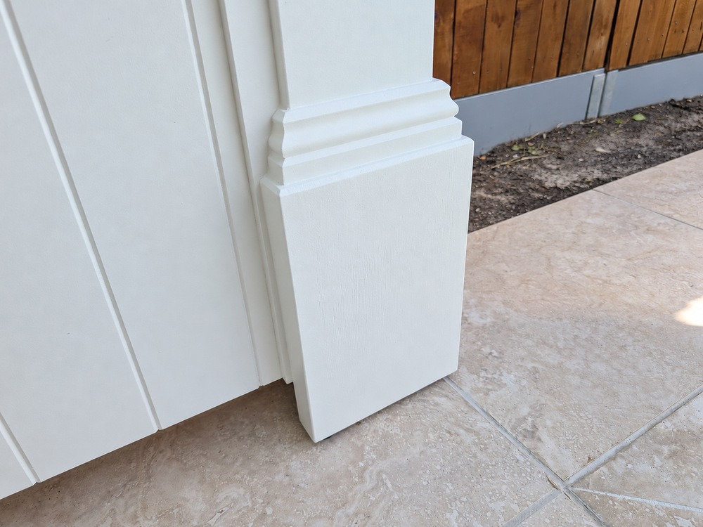 White Decorative Post Box with stepped trim beside the Cabana’s VJ-lined side wall and tiled floor.