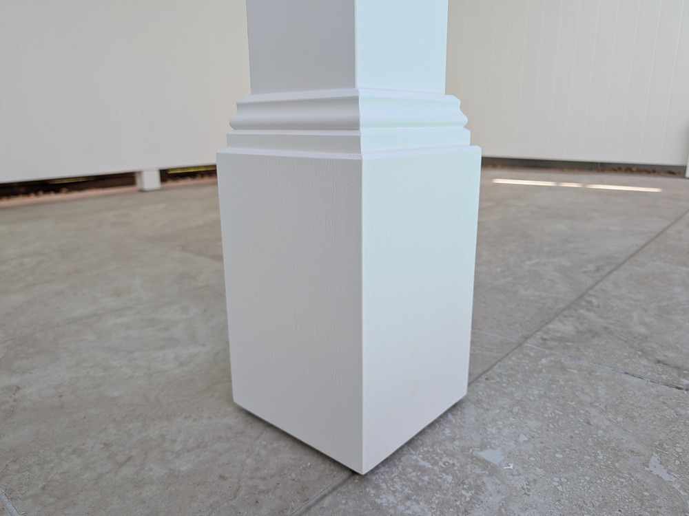 Close view of a white Cabana Decorative Post Box and stepped decorative trim on the tiled pool surround.