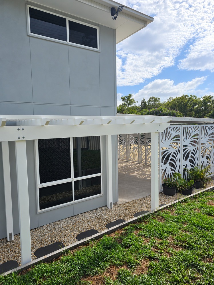 White Pergola framing the walkway to the alfresco area.