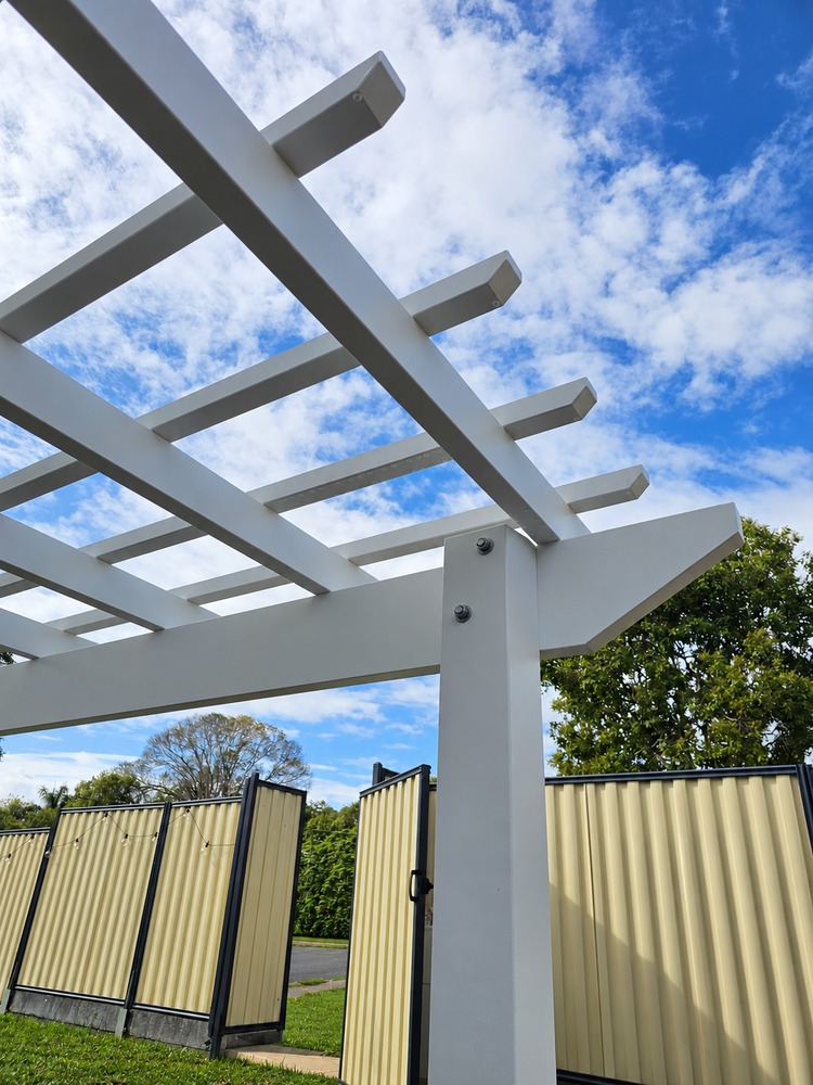 Splayed profile detail on white Traditional Pergola beams and rafters.
