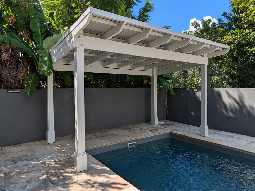 White Roofed Pergola beside the swimming pool, with open sides, exposed timber framing and Decorative Post Boxes.